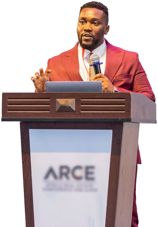 IniOluwa Karunwi in a burgundy suit, speaking into a microphone at a conference lectern